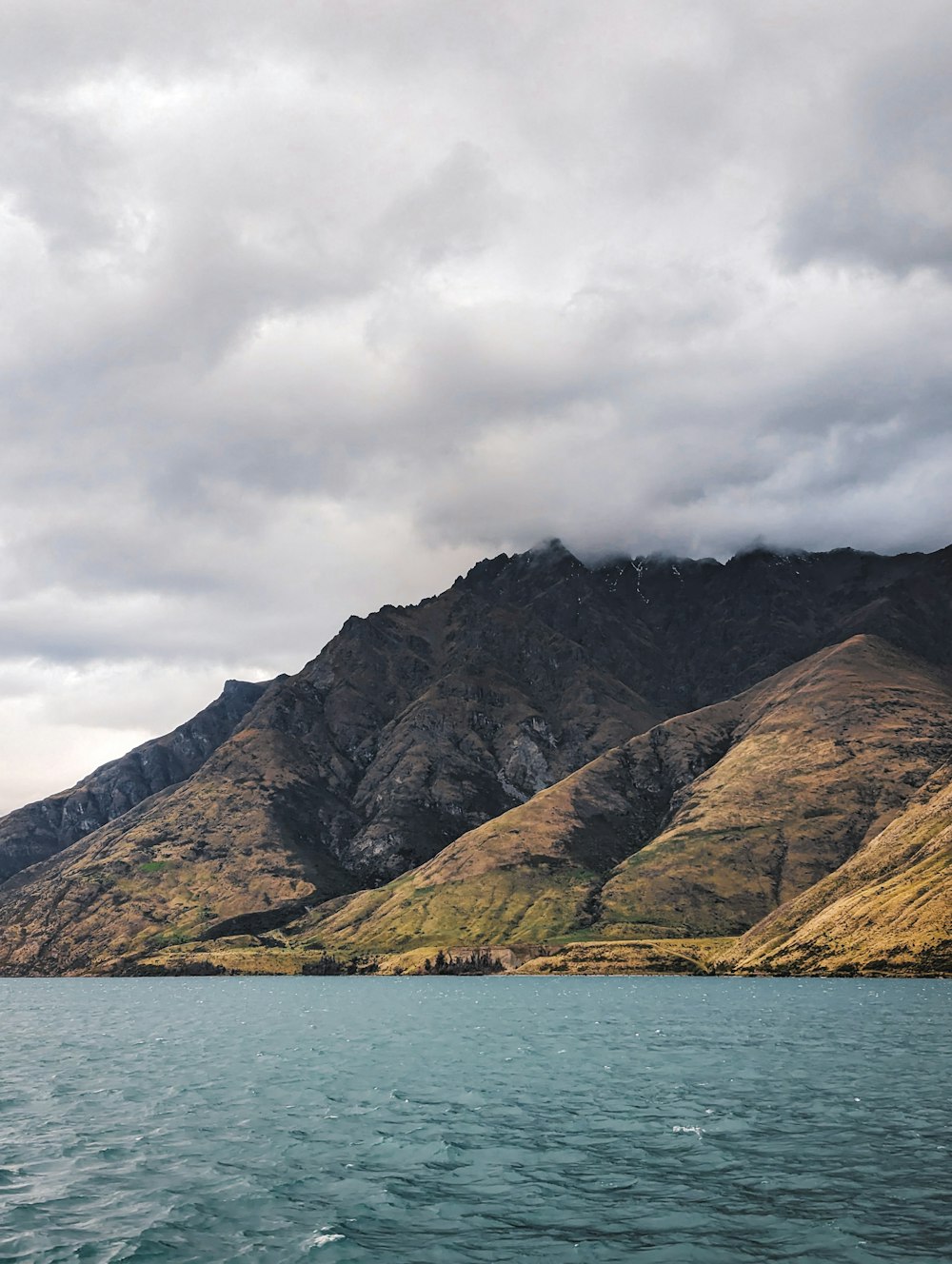 a large body of water with mountains in the background