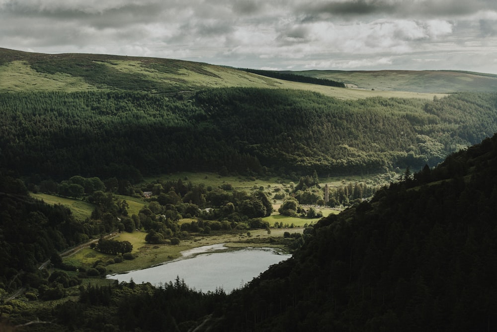 a view of a valley with a lake in the middle