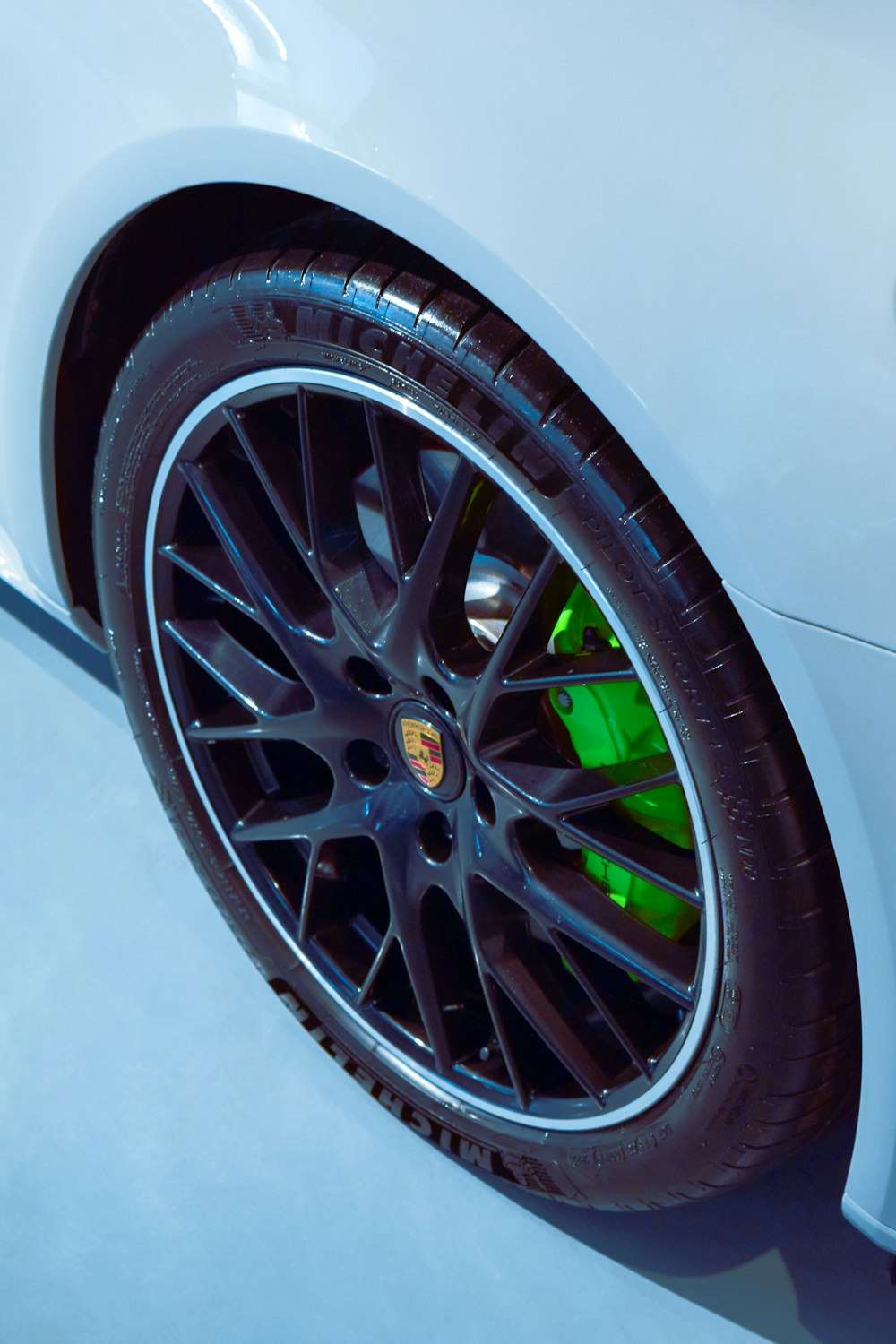 a close up of a white sports car tire