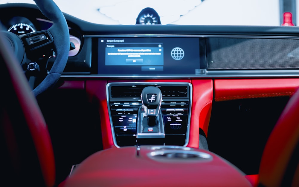 a car dashboard with a red leather seat