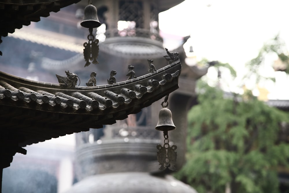 a group of bells hanging from the side of a building