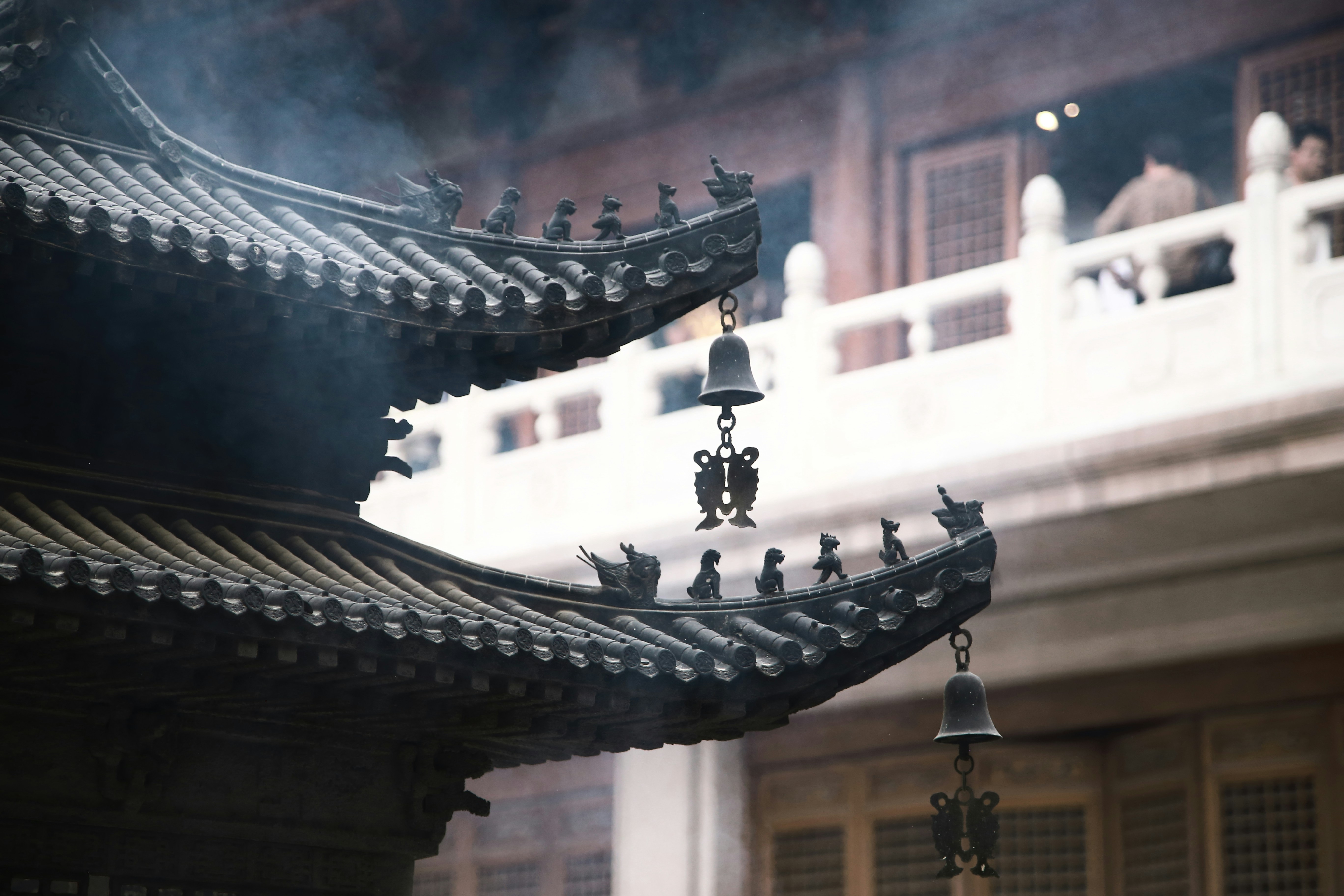 a group of bells hanging from the side of a building