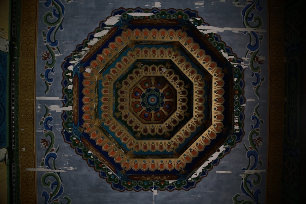 a decorative ceiling in a room with blue walls