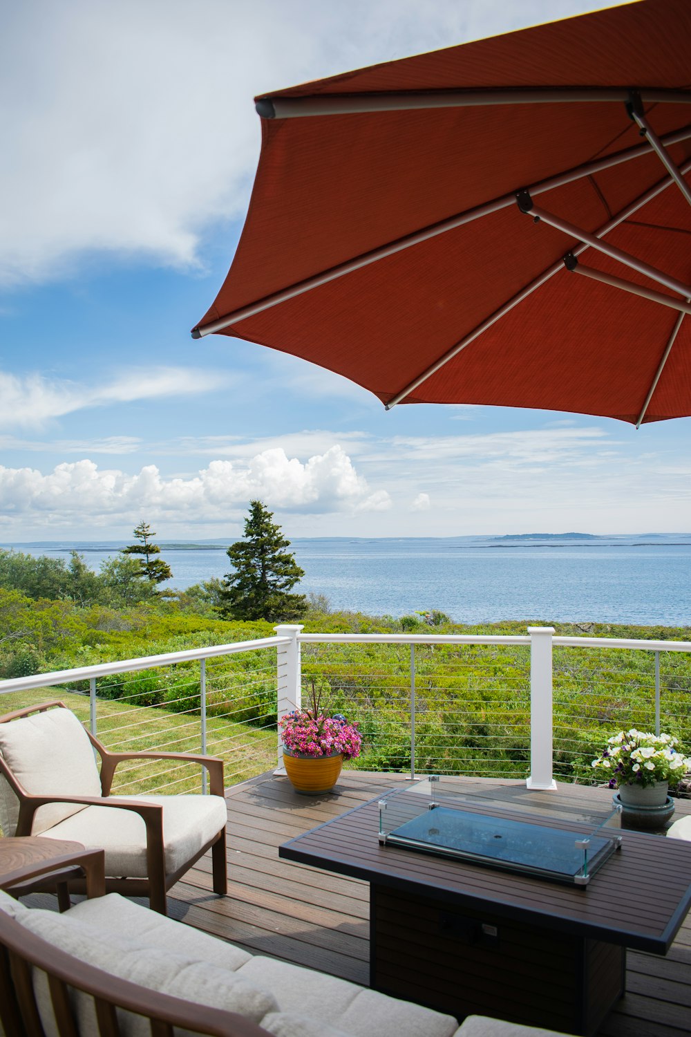 a patio with a table and chairs and an umbrella