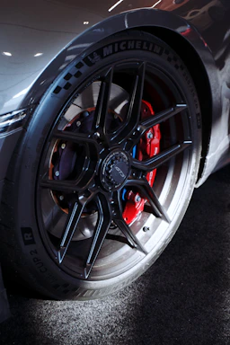 Close-up of a sleek black tire with a red protective seal, symbolizing advanced tire protection technology.