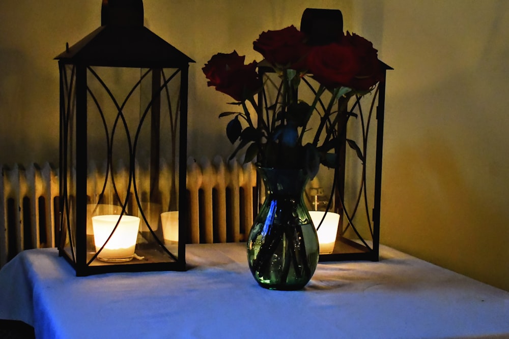 a couple of vases filled with flowers on top of a table