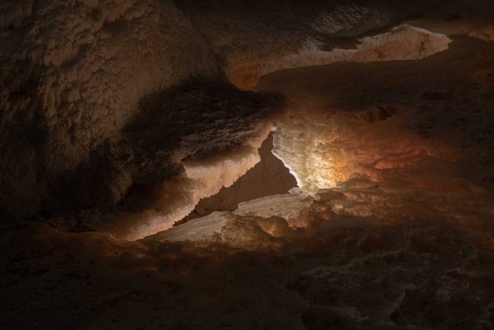 a cave filled with lots of dirt and a light at the end of it