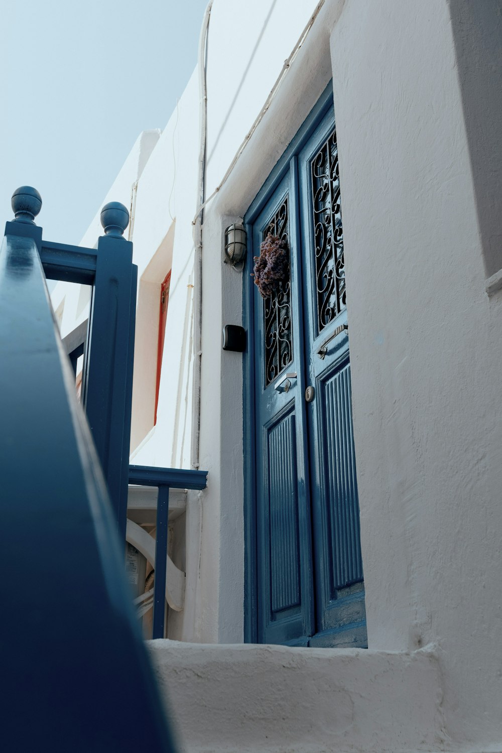 a blue and white building with a blue door
