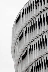 Modern architectural metal facade featuring perforated panels with sharp geometric designs.