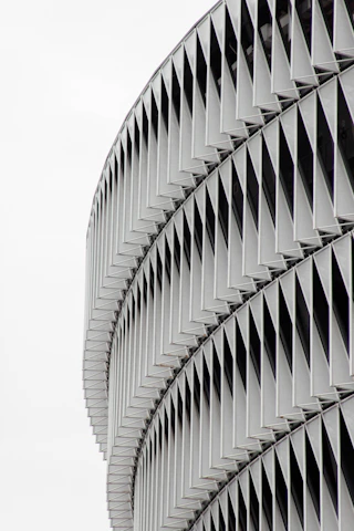 Modern architectural metal facade featuring perforated panels with sharp geometric designs.