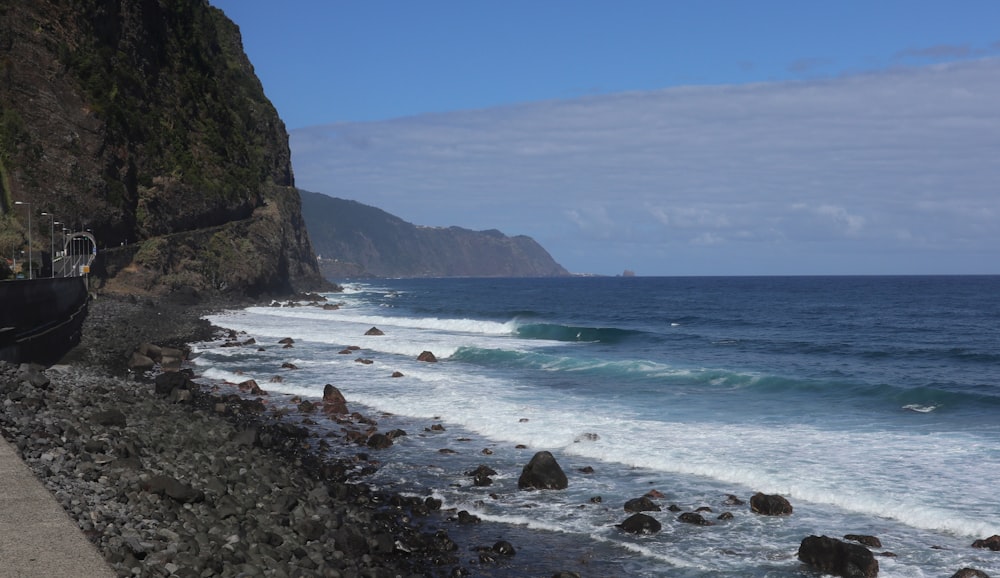 a view of the ocean from the side of a cliff