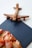 A wooden airplane model is placed on top of a blue document or diploma cover. In the foreground, there is a bouquet of peach and pink roses. The document has an embossed seal with Russian text.