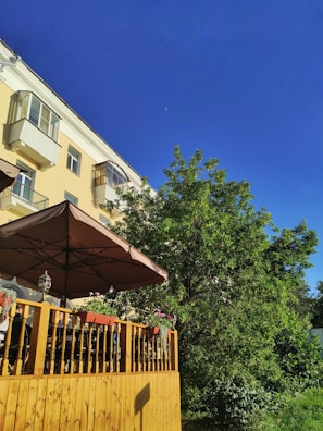 A spacious balcony shaded by a custom-made awning on a clear day.