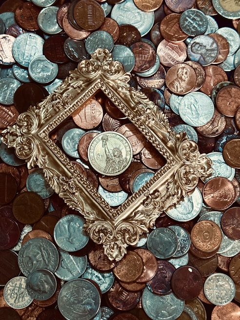 A vintage collection of Indian coins laid out on a wooden table