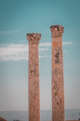 View of weathered columns standing tall against a bright blue sky