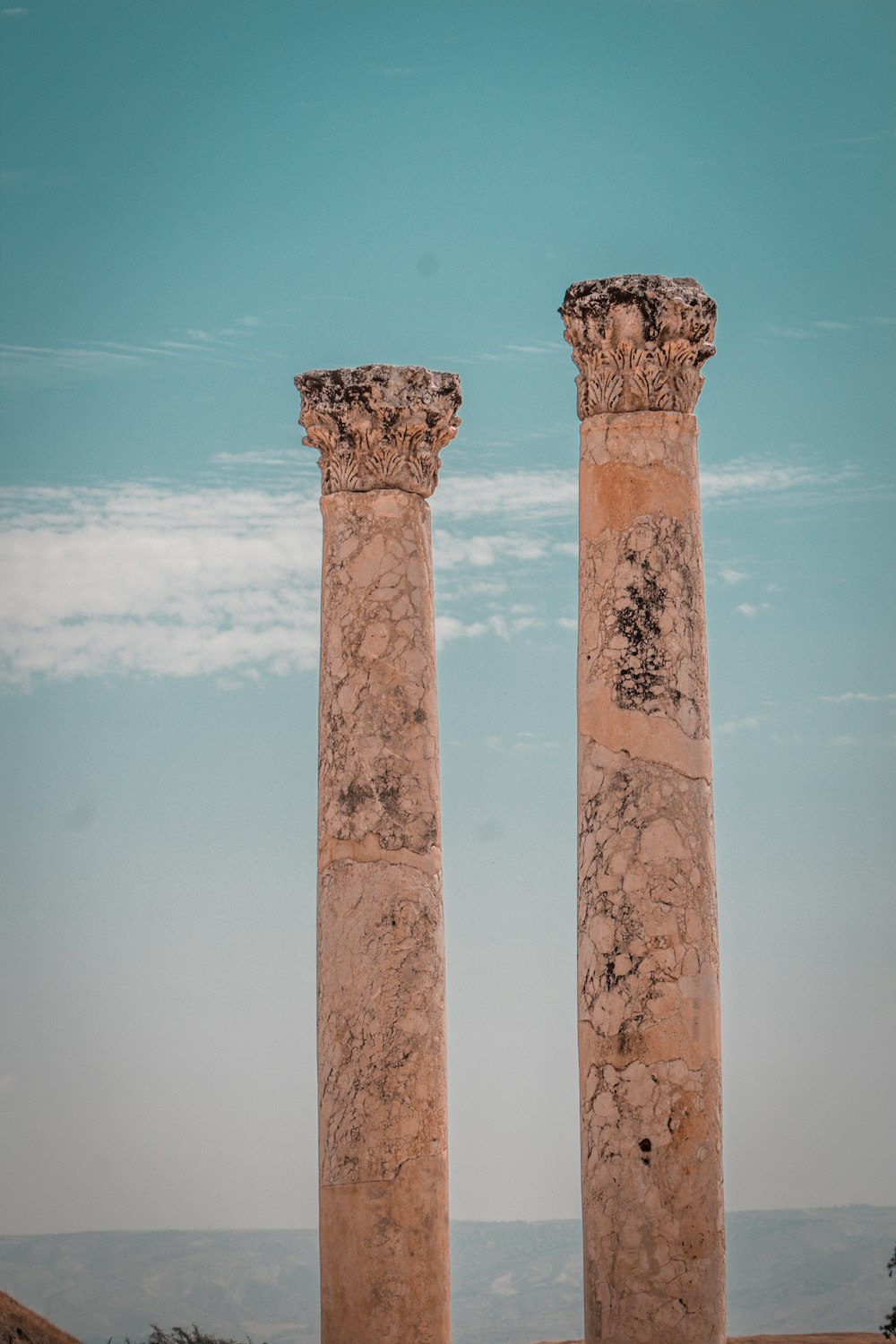 a couple of tall stone pillars sitting next to each other