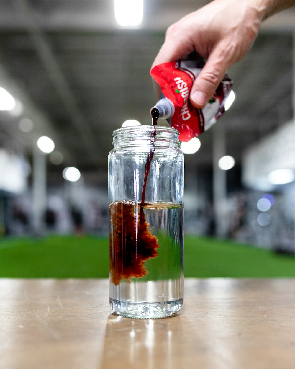 a person is pouring something into a jar