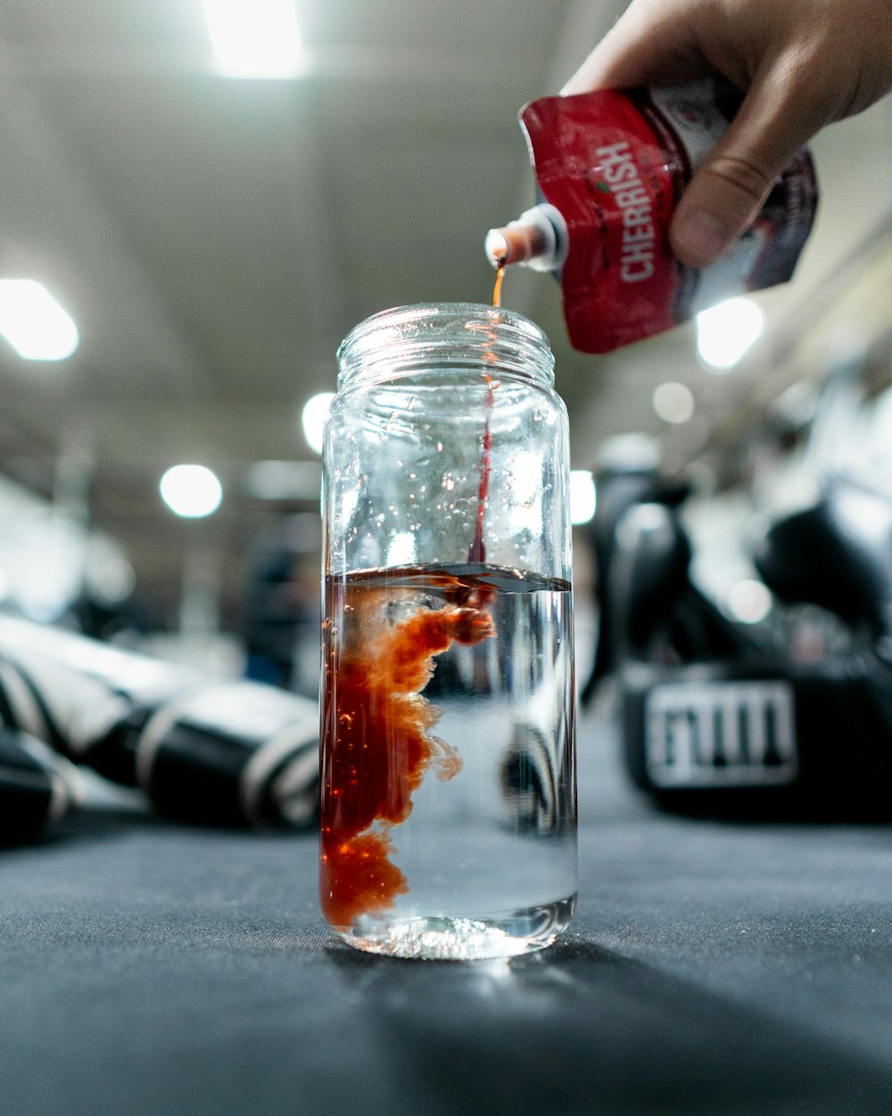 a person is pouring something into a jar