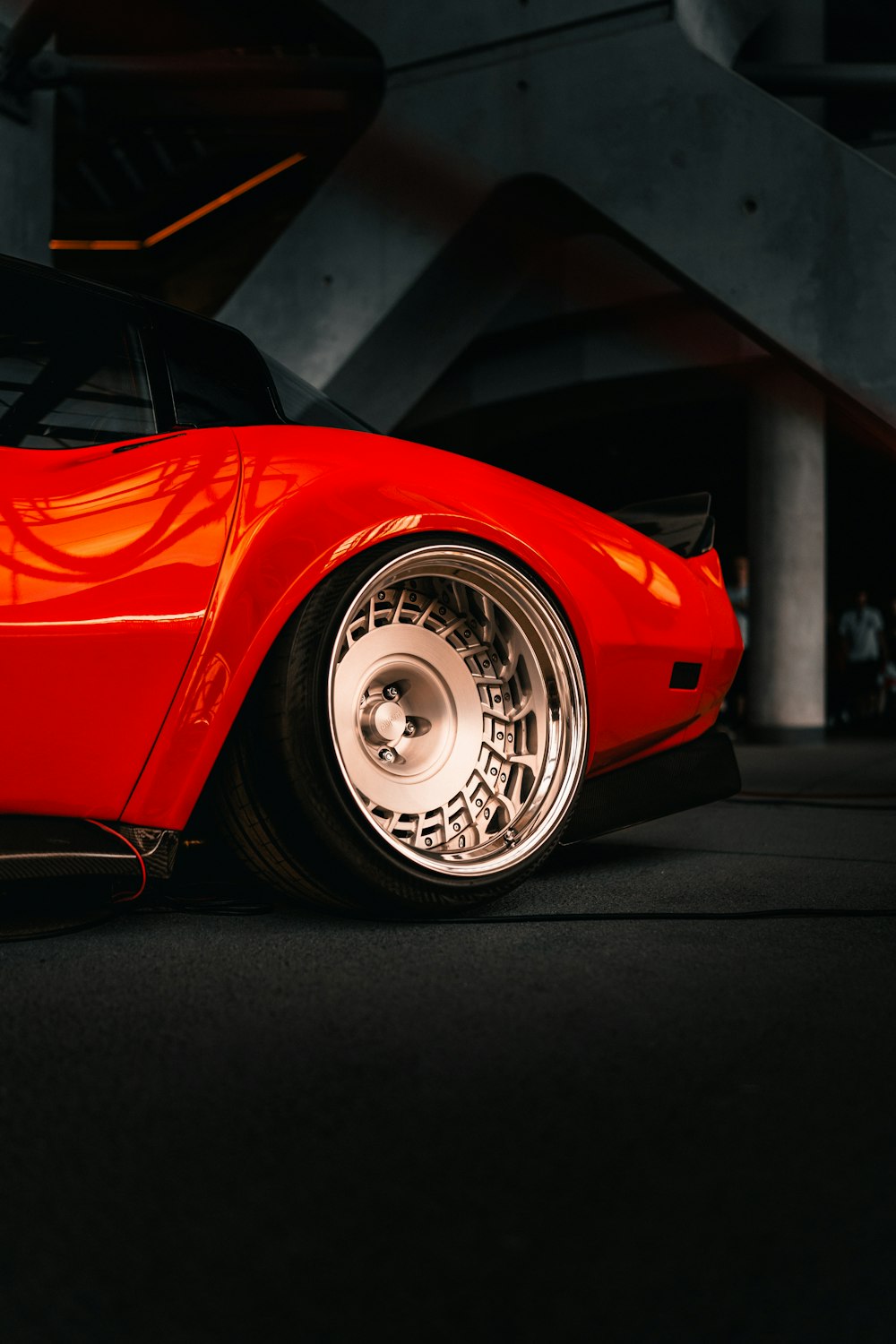 a red sports car parked in a garage