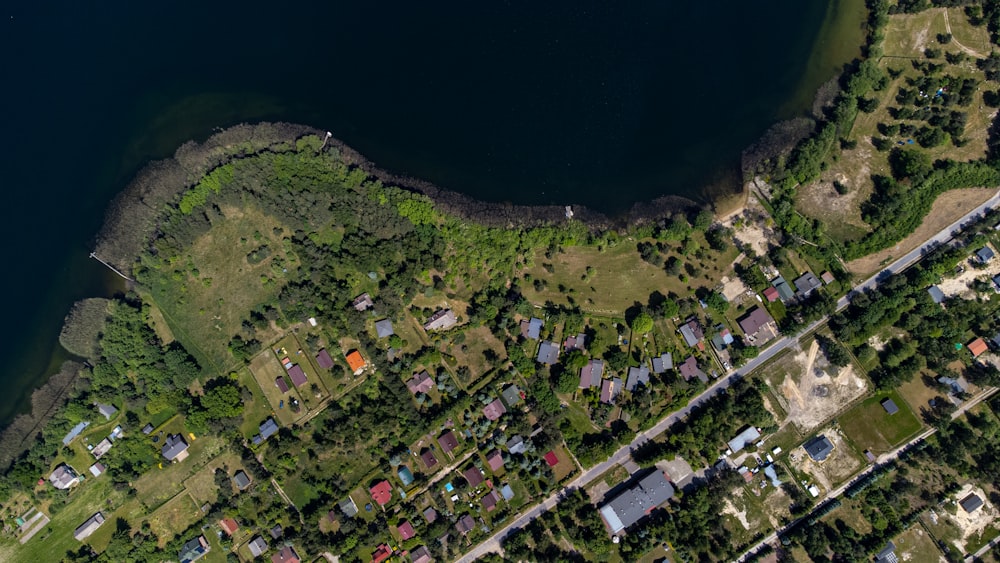 an aerial view of a residential area next to a body of water