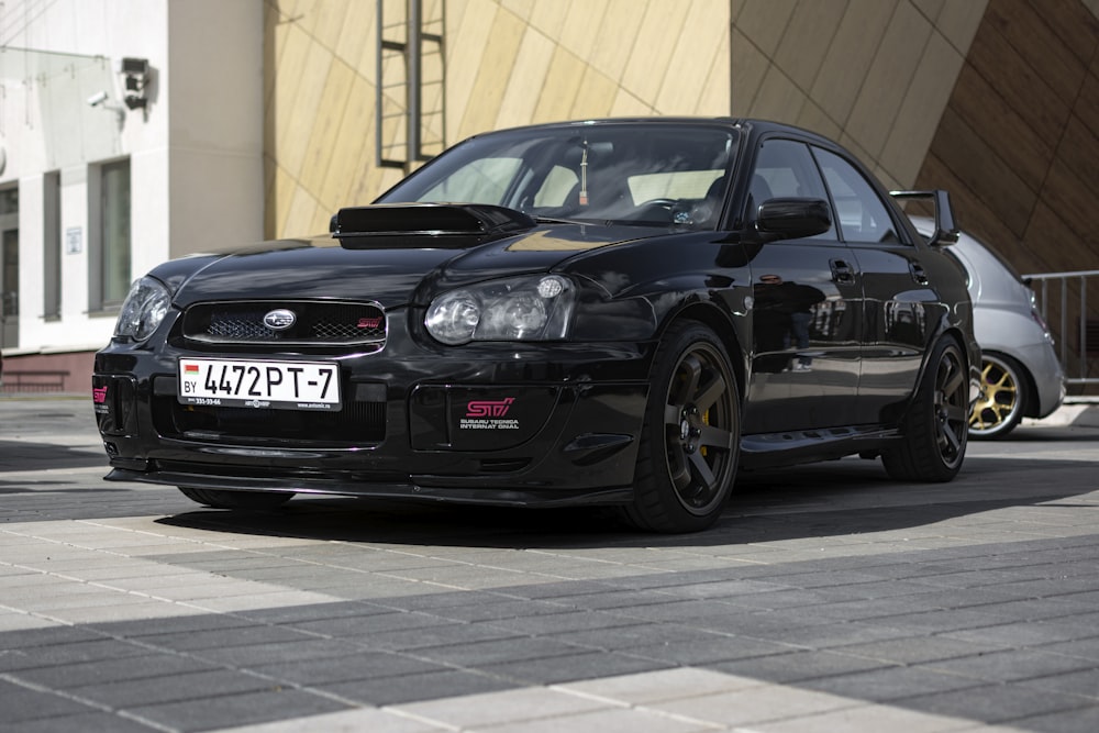 a black car parked in front of a building