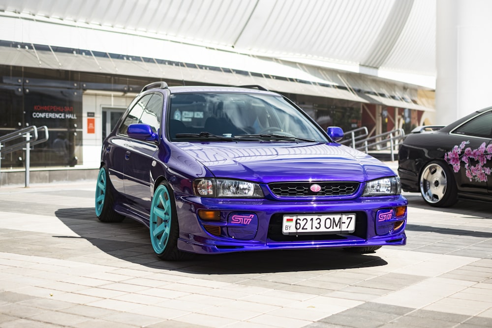 a purple car parked in front of a building