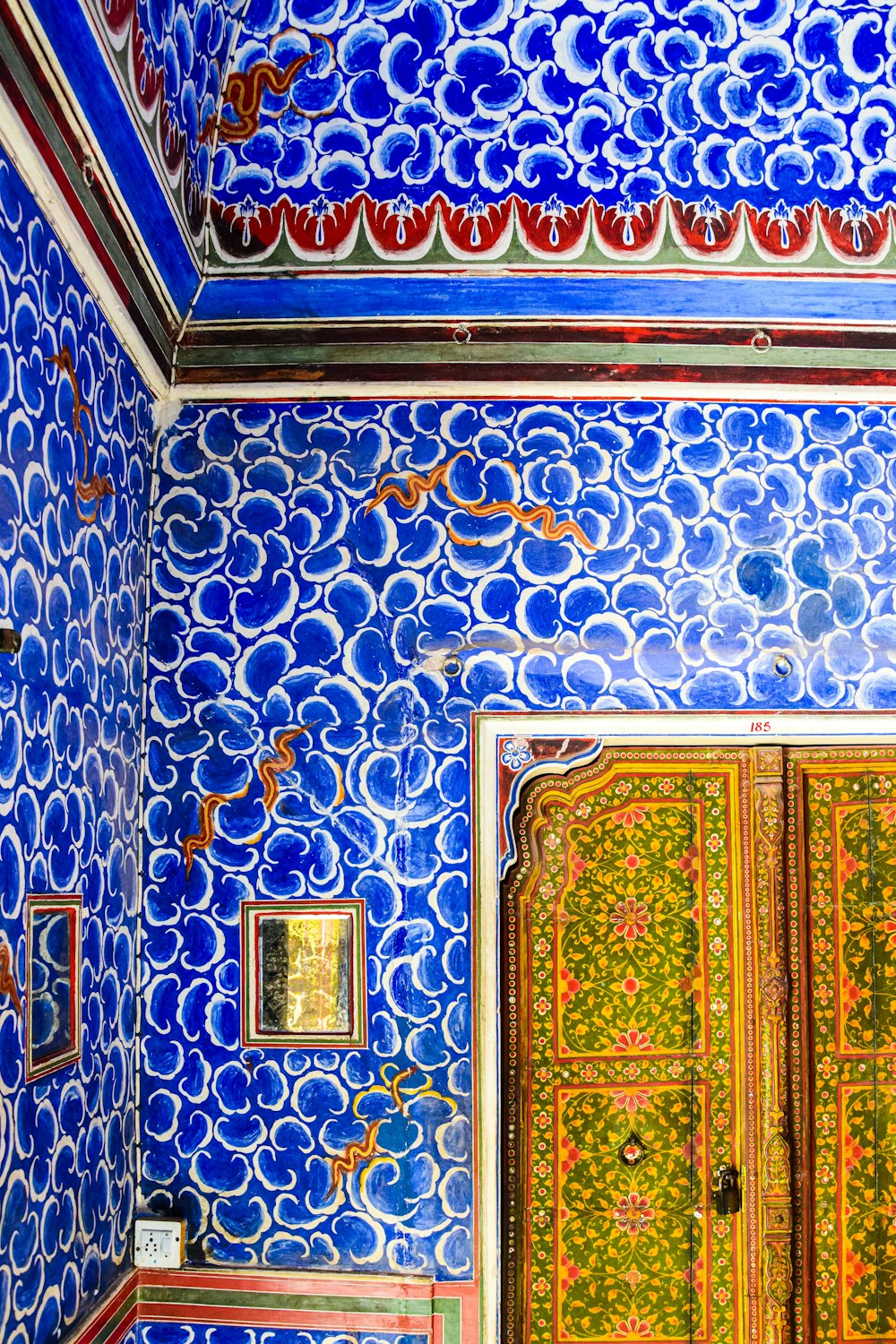 a room with a blue and red wall and a door