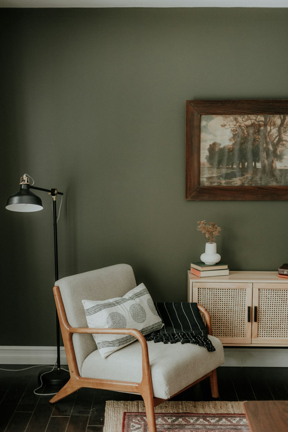 a living room with a chair and a rug