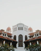 a large white building with a red roof