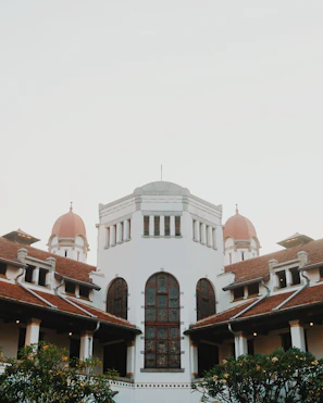 a large white building with a red roof