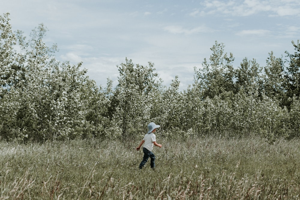 a person in a field with trees in the background