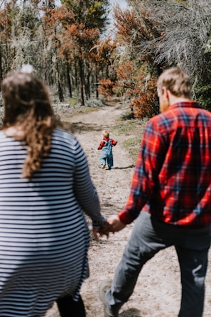 Children and parents hiking together on an easy forest trail during an outdoor adventure.