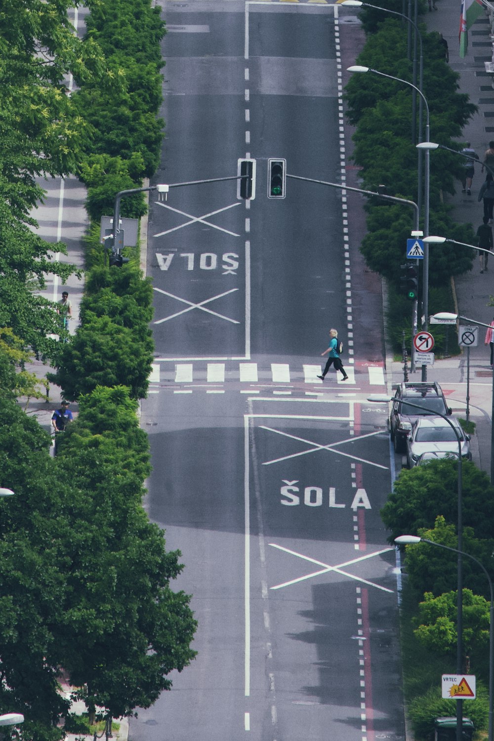a person crossing a street in a city