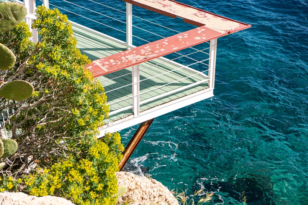 a red and white bridge over a body of water