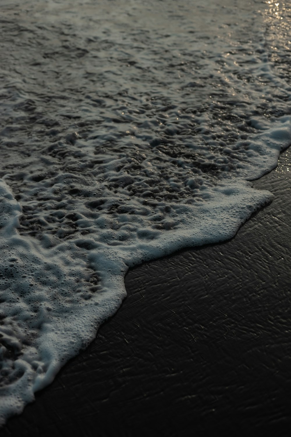 a close up of a wave on a beach