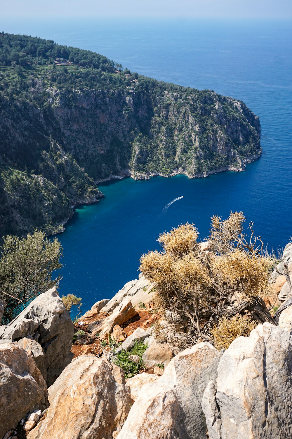 a view of a body of water from a rocky cliff