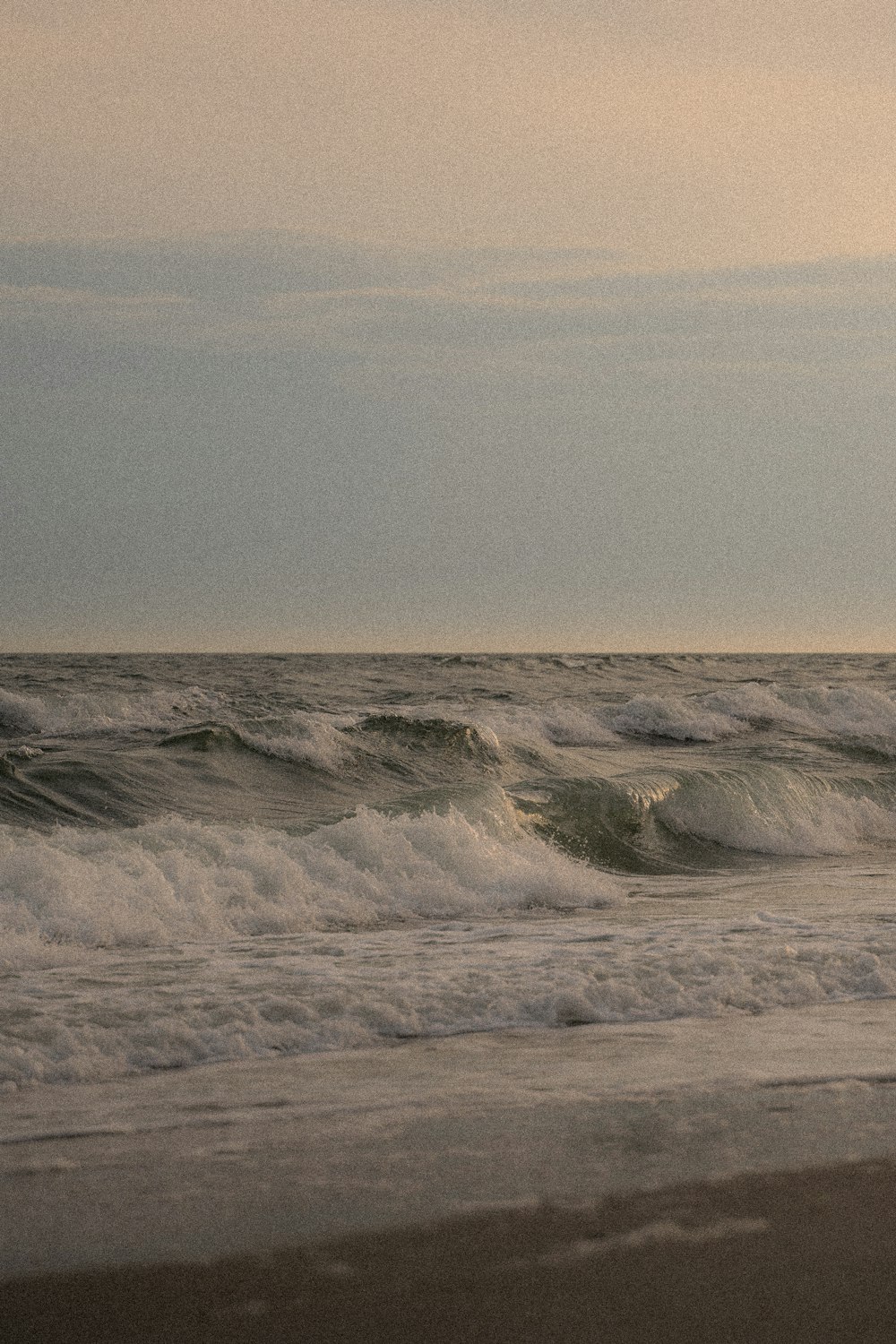 a person riding a surfboard on top of a wave