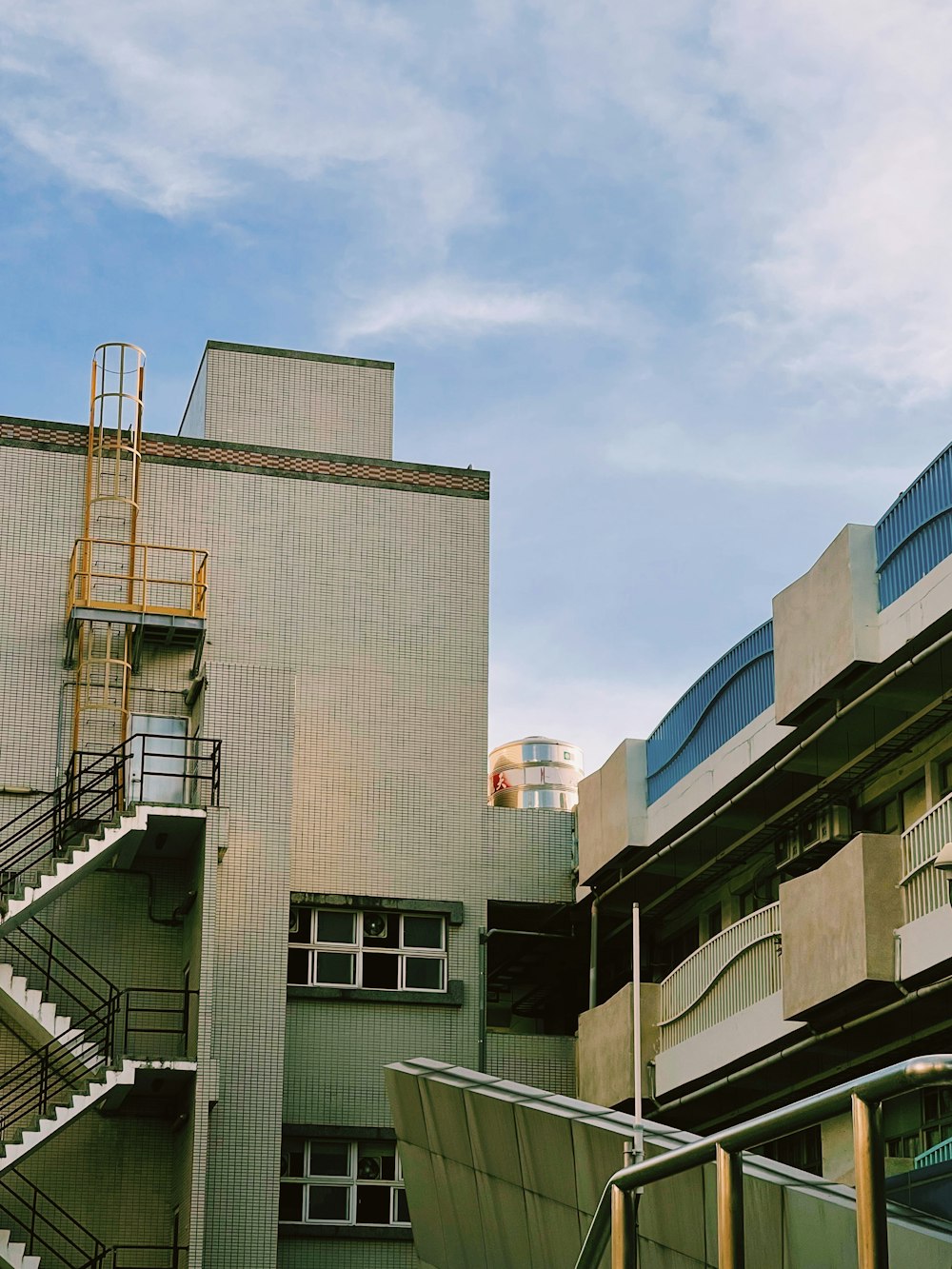 a tall building with a fire escape next to it