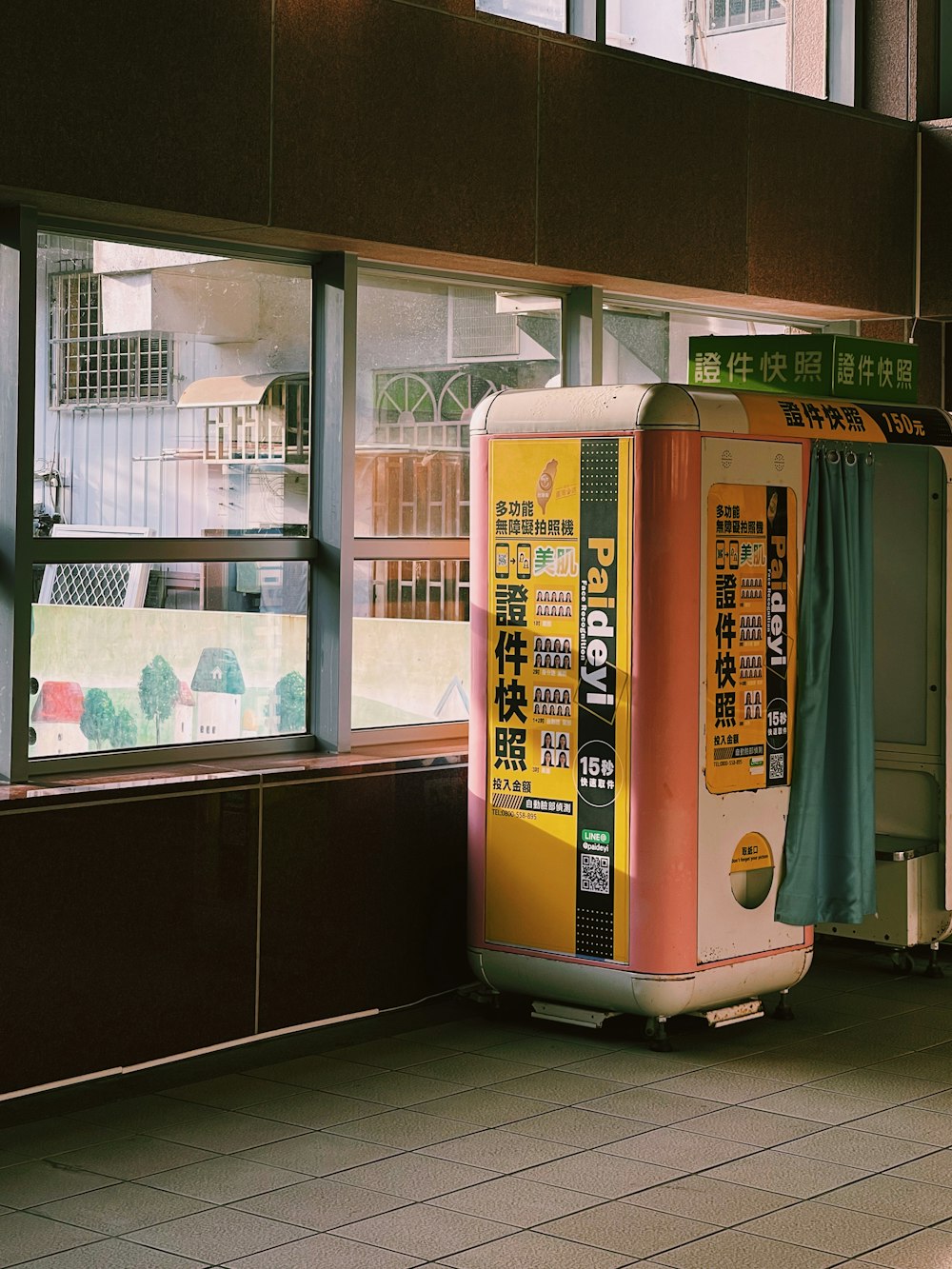 a trash can sitting in front of a window