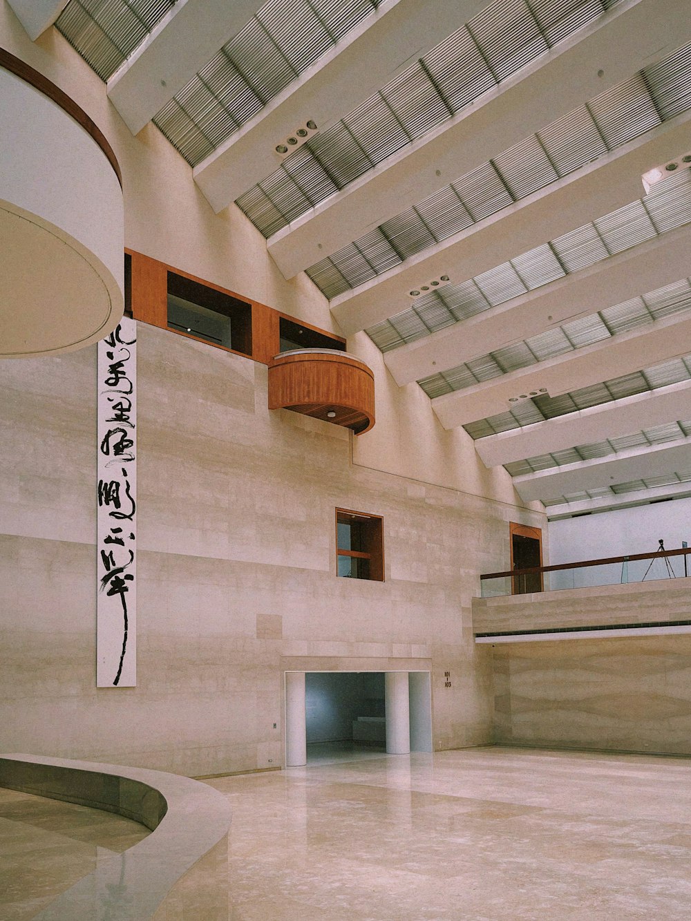 a large room with a staircase and a sign on the wall