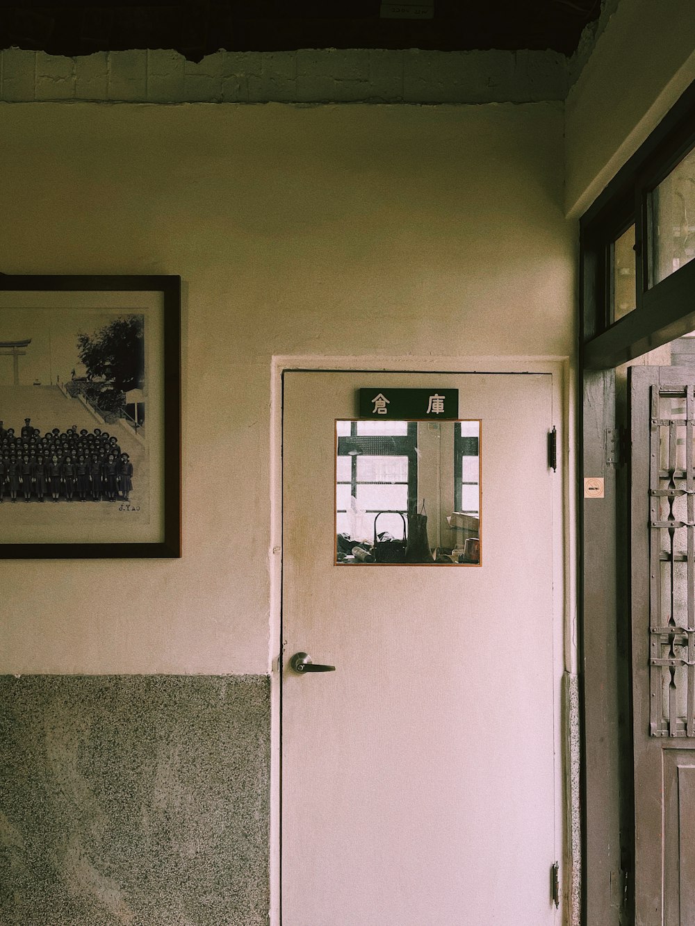 a door with a window and a picture on the wall