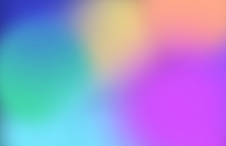 A soft, colorful gradient blends smoothly from one hue to another, featuring shades of blue, green, yellow, purple, and pink.