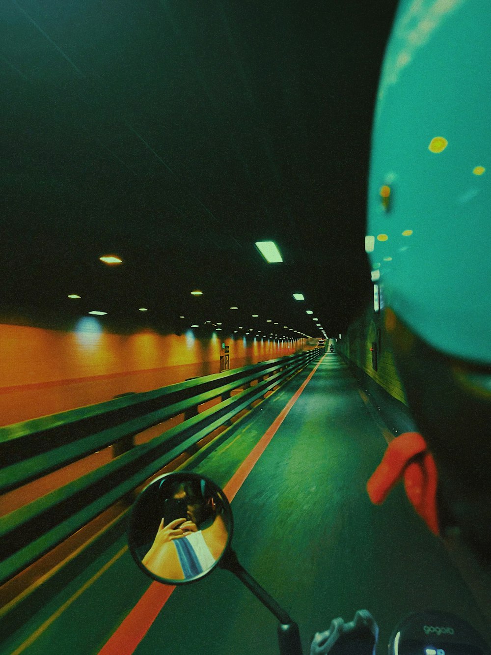 a person riding a motorcycle in a tunnel