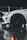 High-angle shot of a white Porsche with crystal clear paint protection film reflecting city lights