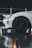 High-angle shot of a white Porsche with crystal clear paint protection film reflecting city lights