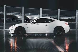 Shimmering wet-look finish on a white sports car freshly detailed and parked in Montreal sunlight.