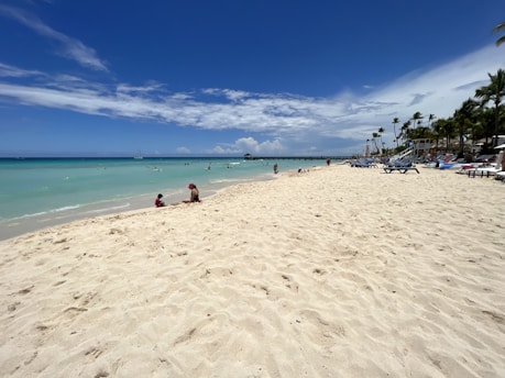 Couple relaxing on a sunny Mexican beach with turquoise waters and palm trees
