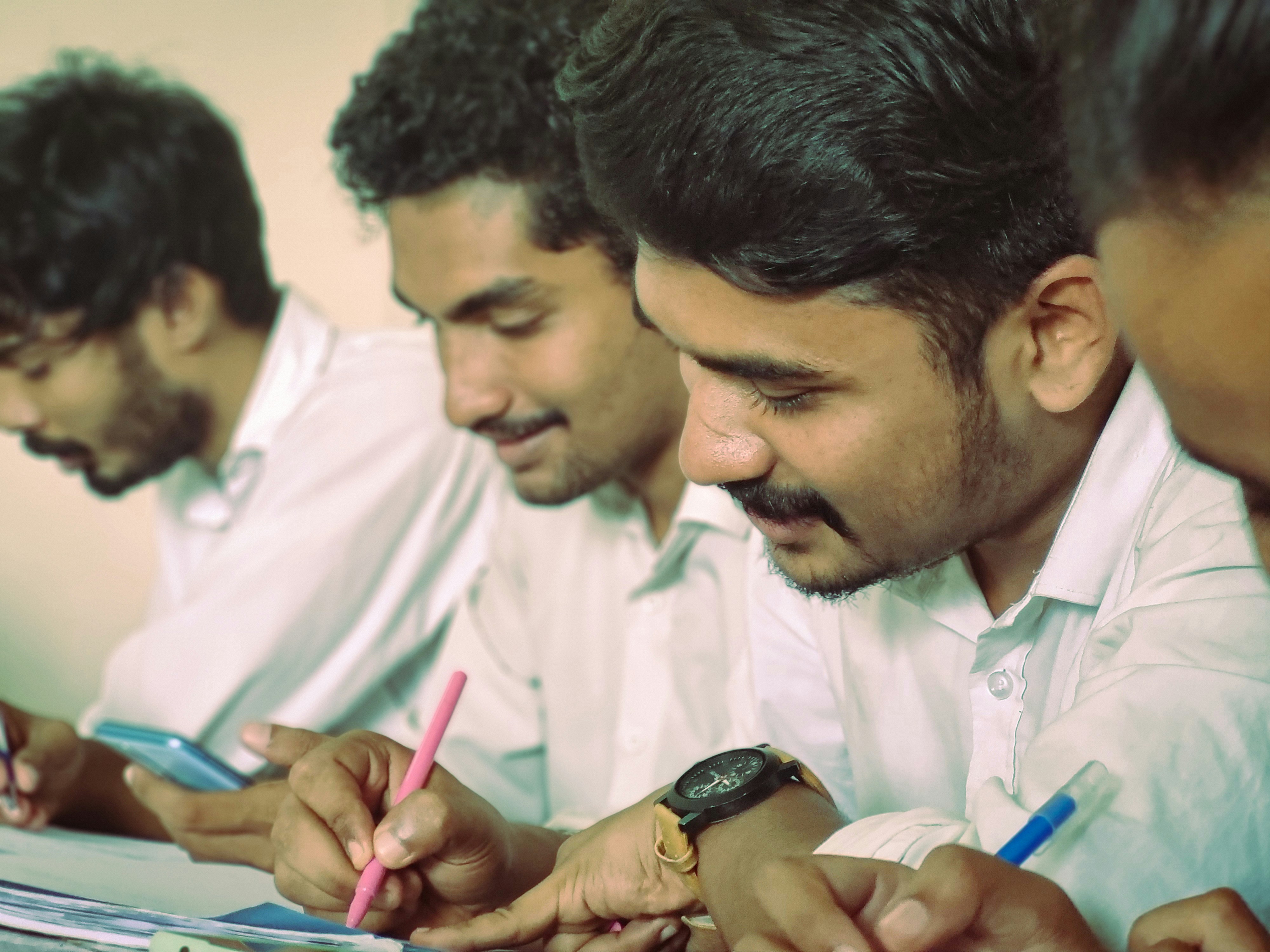 Engineering Students taking down notes during their class