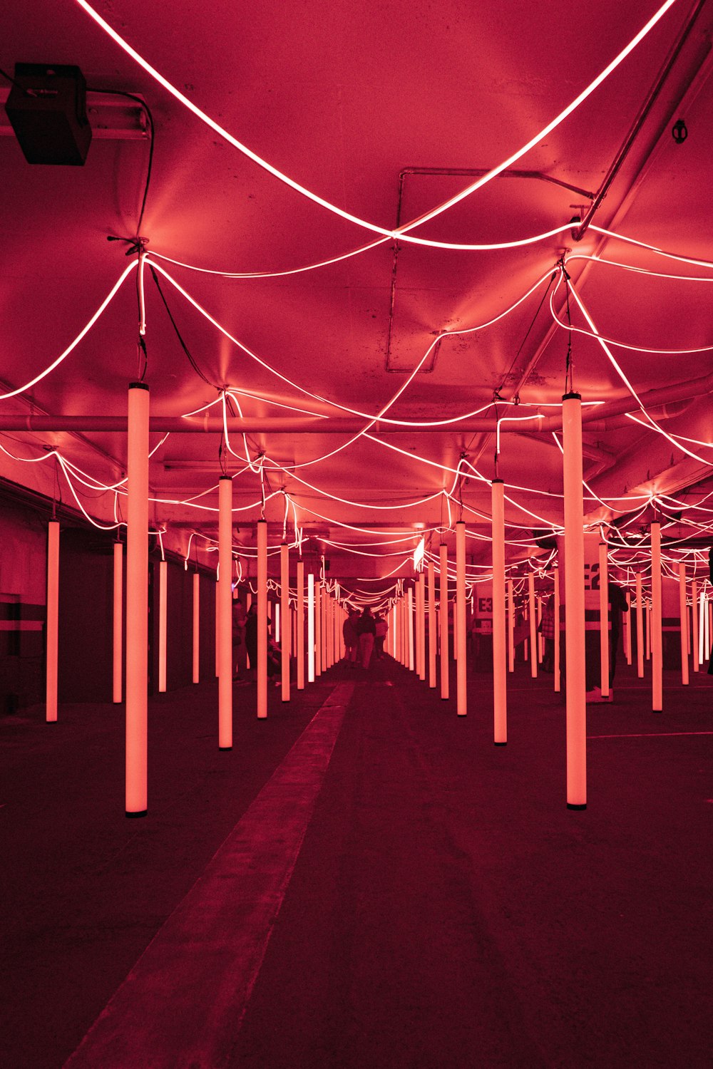 a long hallway with red lights on the ceiling