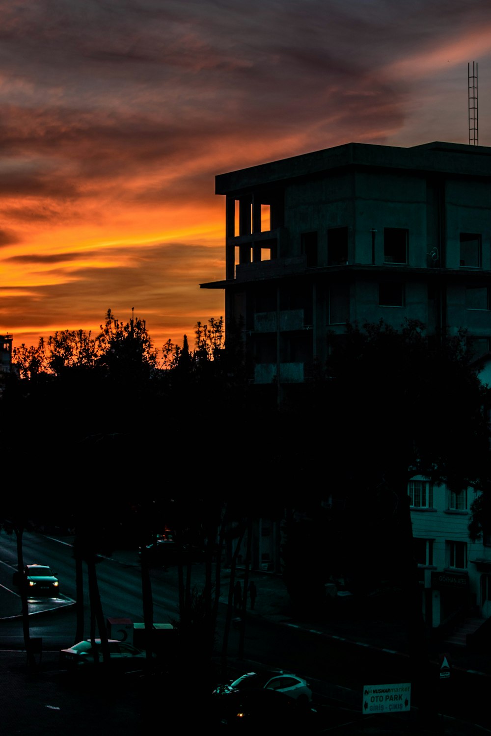 the sun is setting over a city with tall buildings